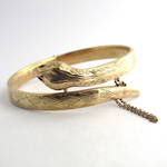 9ct yellow gold hinged snake bangle set with ruby eyes