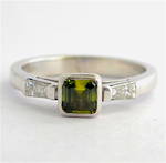 18ct white gold green sapphire and baguette diamond ring