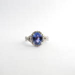 14ct white gold tanzanite and diamond split shank halo style ring