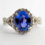 14ct white gold tanzanite and diamond split shank halo style ring