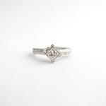 Platinum diamond solitaire crossover style ring